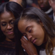 First lady Michelle Obama holds her daughter Malia as President Barack Obama speaks during his farewell address in Chicago on Jan. 10, 2017.
NICHOLAS KAMM/AFP/Getty Images